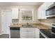 White kitchen with granite countertops and stainless steel appliances at 1742 Lynn Ln, Decatur, GA 30032
