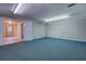 Spacious basement room with blue carpet and access to other rooms at 3061 Stone Bridge Sw Trl, Conyers, GA 30094