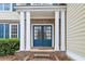 Welcoming entryway with a blue double door and white columns at 3315 Goldmist Dr, Buford, GA 30519