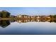 Row of lakefront homes reflecting in calm water at sunset at 210 Rolison Way, Fayetteville, GA 30214