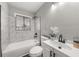 Clean bathroom with white vanity, bathtub, and marble tile at 1396 Iron Gate Blvd, Jonesboro, GA 30238