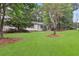 Side view of the house showcasing the white brick and landscaping at 1396 Iron Gate Blvd, Jonesboro, GA 30238