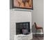 Charming fireplace with white brick surround and wood mantel at 1396 Iron Gate Blvd, Jonesboro, GA 30238