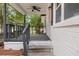 Gray porch with steps, railing, and ceiling fan offers a relaxing outdoor space at 1396 Iron Gate Blvd, Jonesboro, GA 30238