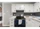 Updated kitchen with stainless steel range and white cabinets at 1396 Iron Gate Blvd, Jonesboro, GA 30238
