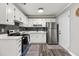 Updated kitchen with white cabinets and stainless steel appliances at 1396 Iron Gate Blvd, Jonesboro, GA 30238