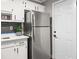 Kitchen area with stainless steel refrigerator and white cabinets at 1396 Iron Gate Blvd, Jonesboro, GA 30238