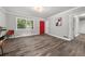Spacious living area with gray walls, wood-look floors, and a red door at 1396 Iron Gate Blvd, Jonesboro, GA 30238