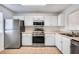 Kitchen with stainless steel appliances and white cabinets at 3950 Stillwater Dr, Duluth, GA 30096