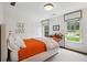 Bright bedroom with orange bedding, built-in desk, and large windows at 663 Carriage Nw Way, Atlanta, GA 30327