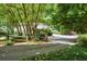 Long driveway leading to a charming home nestled in woods at 663 Carriage Nw Way, Atlanta, GA 30327