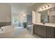 Bathroom featuring double vanity and gray tile flooring at 222 Linford Dr, Locust Grove, GA 30248