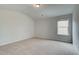 Well-lit bedroom with neutral walls and carpet at 222 Linford Dr, Locust Grove, GA 30248