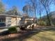 Side view of ranch house showing deck and wooded backyard at 2785 Battle Forrest Dr, Decatur, GA 30034