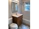 Clean bathroom with shower/tub combo, wooden vanity, and tiled flooring at 2259 Whites Mill Rd, Decatur, GA 30032