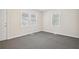Bright bedroom with neutral walls and carpet, featuring two windows at 2259 Whites Mill Rd, Decatur, GA 30032