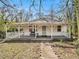 Charming white cottage with a wraparound porch and landscaped yard at 2259 Whites Mill Rd, Decatur, GA 30032