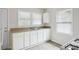 Simple kitchen with white cabinets, laminate countertops, and gas range at 2259 Whites Mill Rd, Decatur, GA 30032