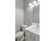 Clean bathroom with white vanity, toilet, and mirror at 5667 Cascade Sw Run, Atlanta, GA 30336