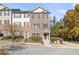 Brick three-story townhome with front yard and driveway at 5667 Cascade Sw Run, Atlanta, GA 30336