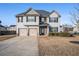 Two-story house with a two-car garage, driveway, and front lawn at 520 Harmony Way, Locust Grove, GA 30248