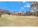 Brick ranch-style home with a red metal roof, situated on a large grassy lot at 821 Peeples Valley Nw Rd, Cartersville, GA 30121