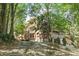 Brick building nestled in a wooded area with stone steps at 266 11Th Ne St # 308, Atlanta, GA 30309