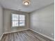 Well-lit bedroom with wood-look floors and a large window at 6643 Wandering Way, Norcross, GA 30093