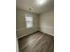 Cozy bedroom with wood-look flooring and large window at 671 Bedford Ct, Woodstock, GA 30188