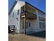 Rear view of a white two story house with large windows and deck at 2004 Stonecreek Dr, Woodstock, GA 30188