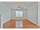 Bright bedroom with hardwood floors and ceiling fan at 714 Carlton Pointe Way, Palmetto, GA 30268