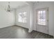 Bright dining room with elegant chandelier and wood-look flooring at 1326 Avington Glen Way, Lawrenceville, GA 30045