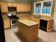 Eat-in kitchen with granite countertops and island at 1853 Rosedown Ct, Lawrenceville, GA 30043