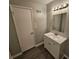 Bathroom features a vanity with a mirror and a door at 5085 Rock Glen Dr, Stone Mountain, GA 30088