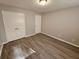 Large bedroom with double doors leading to a closet and wood-look floors at 5085 Rock Glen Dr, Stone Mountain, GA 30088