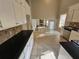 Modern kitchen with white cabinets and granite countertops at 5085 Rock Glen Dr, Stone Mountain, GA 30088