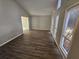 Spacious living room with wood-look floors and large windows at 5085 Rock Glen Dr, Stone Mountain, GA 30088