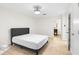 Main bedroom with a dark gray bed, light wood-look floors, ceiling fan, and ensuite bathroom access at 906 Country Park Se Dr, Smyrna, GA 30080