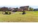 Large backyard with green lawn, landscaping and basketball court at 120 Broad Meadows Ln, Fayetteville, GA 30215