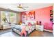 Stylish bedroom with a bed, pink accent wall, and large window at 120 Broad Meadows Ln, Fayetteville, GA 30215