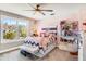 Cozy bedroom with a bed, window seat, and built-in shelving at 120 Broad Meadows Ln, Fayetteville, GA 30215