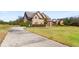 Two-story house with a long driveway and manicured lawn at 120 Broad Meadows Ln, Fayetteville, GA 30215