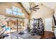 Home gym with equipment, hardwood floors, and pool views at 120 Broad Meadows Ln, Fayetteville, GA 30215