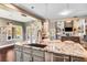 Open kitchen with granite island, stainless steel appliances, and breakfast bar at 120 Broad Meadows Ln, Fayetteville, GA 30215
