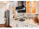 White kitchen features granite countertops, stainless steel appliances, and glass-front cabinets at 120 Broad Meadows Ln, Fayetteville, GA 30215