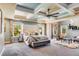 Luxurious main bedroom with coffered ceiling, plush bedding, and a sitting area at 120 Broad Meadows Ln, Fayetteville, GA 30215