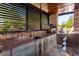 Outdoor kitchen features granite countertops, stainless steel appliances, and custom cabinetry at 120 Broad Meadows Ln, Fayetteville, GA 30215