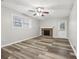 Gathering room with brick fireplace, wood-look floors, and ceiling fan at 245 Brookclear Ln, Fayetteville, GA 30215