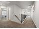 Upstairs hallway with carpet, doors to bedrooms, and a staircase at 419 Woodmill Sw Way, Atlanta, GA 30331