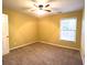 Bright bedroom with yellow walls, carpet flooring, and a ceiling fan at 2765 Hunters Pond Ln, Snellville, GA 30078